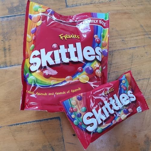 Image of family and single pack of skittles