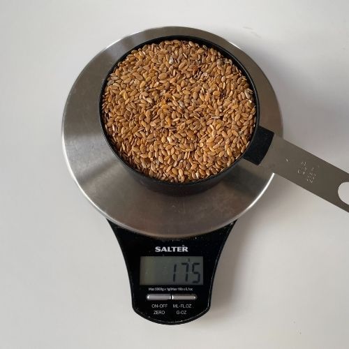 weight to show a cup of flax seed on a scale weighing 175g