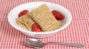 shredded wheat in a bowl with strawberries