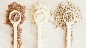 various kinds of seeds on spoons to show article is about seeds