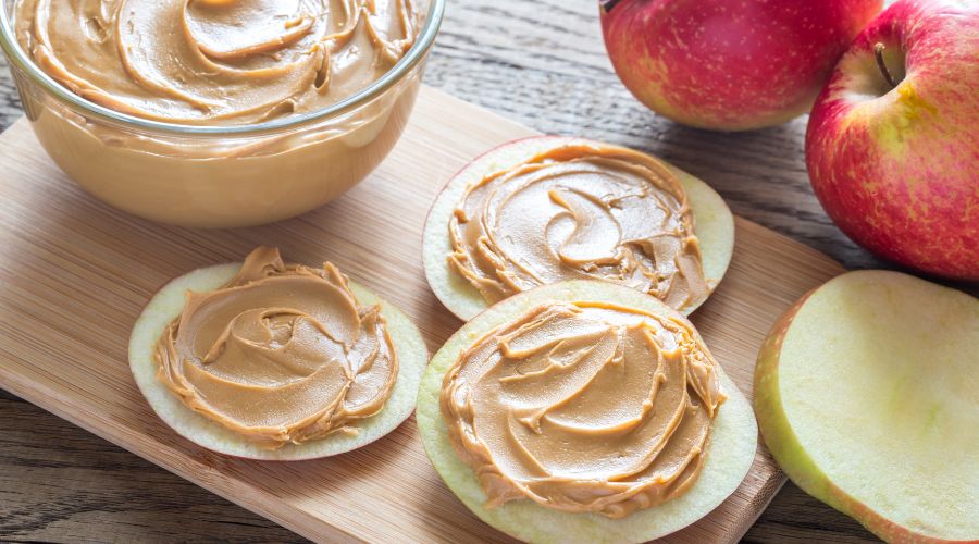 peanut butter spread on apple, to show a low carb peanut butter snack