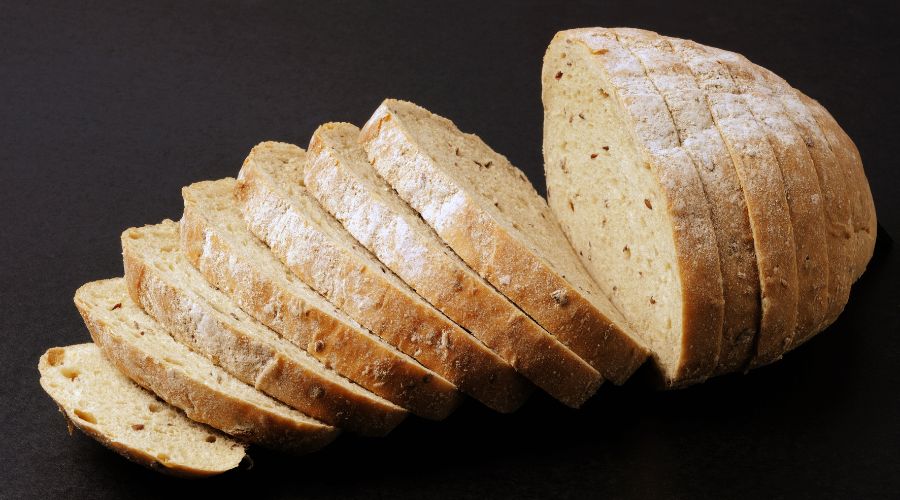 sliced whole grain bread on a black background