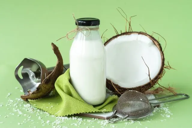 Coconut and a bottle of coconut milk