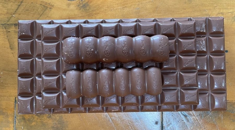 different sized Cadbury Dairy Milk to show how many squares are in a bar