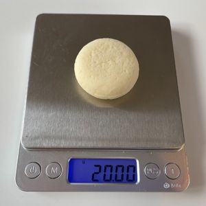 image shows a babybel on a scale weighing 20g per original mini chese