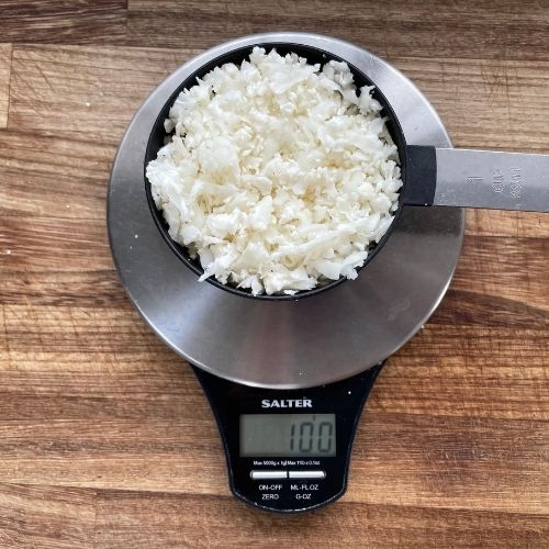 image to show a cup of cauliflower rice on a scale weighs 200g