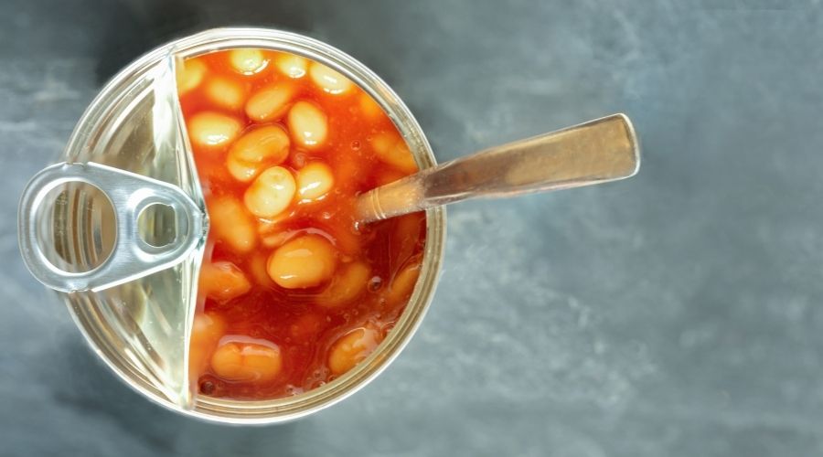 open can of baked beans with a spoon
